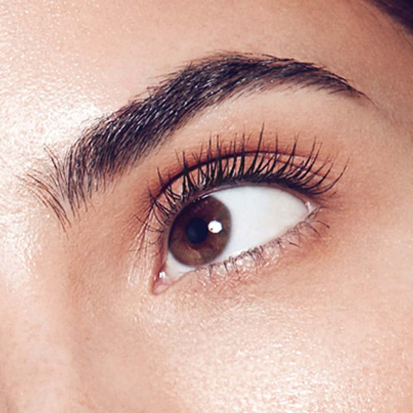 Close-up of beautiful, full eyebrows on a woman's face. The eyebrows are perfectly shaped and have a natural, thick appearance. They frame the eyes beautifully and give the face a polished, put-together look.